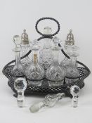 A large silver plated and cut glass cruet set having two cut glass sugar castors with HM silver