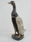 A c1960s clothes brush in the form of a plasticised standing duck, 28cm high.