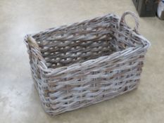 A large wicker work log basket having twin handles, 73 x 48 x 52cm.