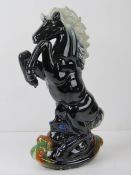 A contemporary lustre painted figuring of a rearing horse, 36cm high.