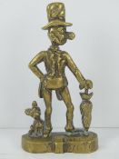 A vintage cast brass doorstop of a large nosed gentleman with hat and umbrella, dog at foot,