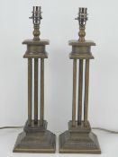 A pair of contemporary table lamps of column form, wired for electricity,