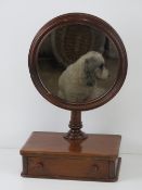 An unusual mahogany gentleman's shaving mirror having drawer under and adjustable round mirror