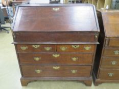 An early 19th cenmtury fall front campaign type (top/bottom sectioned) bureau having two short over