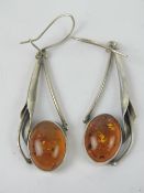 A large pair of Art Nouveau style Baltic amber and silver earrings, 6.1cm drop inc hanger.