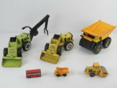 Three Tonka toys being dumper truck, loader and trencher.