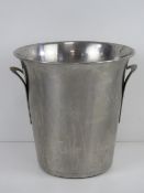 A stainless steel champagne ice bucket or wine cooler, 21cm high.