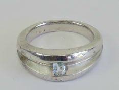 A HM silver ring having central aquamarine to the wide two sectional band, hallmarked for Sheffield,