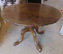 A circular occasional table raised over