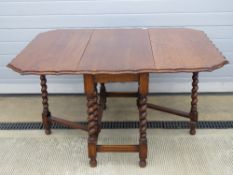 A substantial oak drop leaf table having