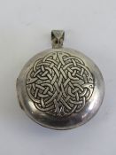 A large HM silver Celtic locket having Irish blessing and knot design upon 'May the road rise to