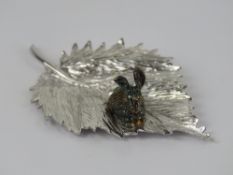 An unusual and superbly made HM silver ornament in the form of a gilded rabbit upon a leaf,