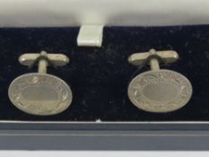 A pair of unengraved silver cufflinks in