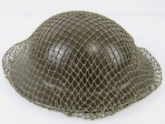A WWII British Brodie helmet, dated 1939