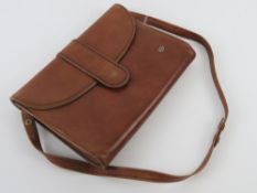 A vintage tan leather handbag having sue