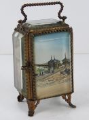 A late Victorian pocket watch holder, French made with bevelled glass and ormolu having painting