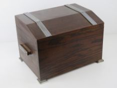 An Art Deco stained oak tea caddy, lid lifting to reveal pull-out compartment within,