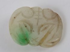 A single jade button 'mutton fat' white with green fleck carved in the form of a rams head, 1.7cm