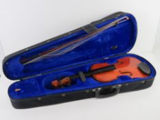 A violin for re-stringing, with bow, in case.
