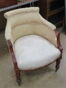 An Edwardian tub chair for re-upholstering having ceramic castors.