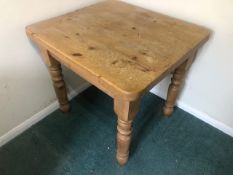 A square shaped Victorian style pine table raised over turned legs, single drawer under, 81 x 81 x
