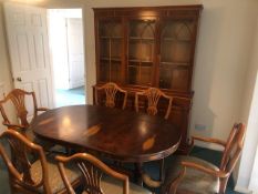 An oval Yew wood extending dining table (196 x 91cm extended) raised over twin pedestals, with six