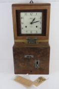 A National Time Recorder Company clocking-in machine, enamelled dial with Arabic numerals and marked