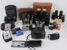 A quantity of assorted cameras and binoculars.