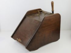 An Edwardian mahogany and brass coal Purdonium or scuttle with shovel.