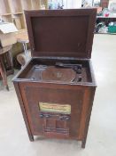 An early New Universal radiogram having turntable with Bakelite stylus to the top, forward facing