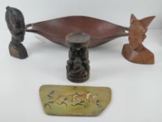 A carved African rosewood bust together with a carved wooden bowl, a carved wooden candle stand, a
