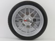 A contemporary wall clock in the form of a wheel having 'alloy', brake disc and caliper. 36cm