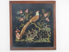 A fine wool work embroidery on black ground of a bird on blossoming branch with fencing below, 51