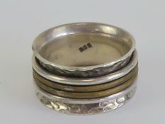 A handmade worry ring (stress ring / fidget ring) having four rotating central bands, stamped 925,