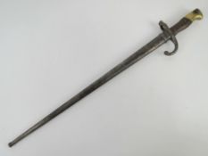 A French 1874 pattern Gras bayonet with scabbard, engraved to spine 
