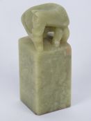A 19th century Oriental square shaped jade seal surmounted with carved horse upon,
