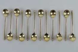 A set of twelve silver coffee spoons having barley twist handles and traditional Northern European
