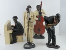 A contemporary set of four jazz band figurines inc singer, saxophone player,