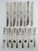 A set of HM silver dinner knives and forks for twelve settings by William Hutton & Sons Ltd,
