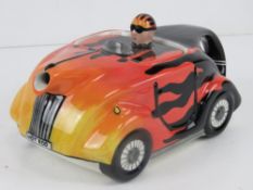 A Lorna Bailey teapot in the form of a racing car, 'Hot Rod' pattern,
