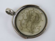 A Victorian double sided carved chalcedony spinning fob pendant seal having monogram with male