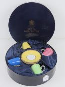 Royal Worcester; A boxed set of four coffee cans and saucers in celebration of HRH 80th Birthday.