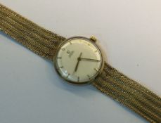 An Omega 9ct gold automatic wristwatch, cream dial with baton points,