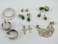 A quantity of silver and white metal earrings including malachite, Yin Yang, hoops, crucifix, etc.