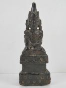 An unusual leather covered wooden shrine figurine, probably Tibetan,