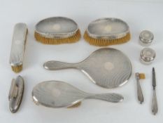 An HM silver dressing table set comprising mirror, hairbrush, two rouge pots,