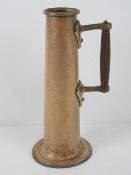 An Arts & Crafts 'trench art' style copper jug with wooden handle standing 31cm high.