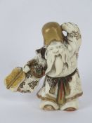 A finely carved and details Oriental netsuke, unsigned, standing 6cm high.