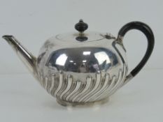 A Victorian HM silver teapot having ebonised wooden handle and finial,