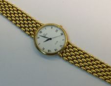 An 18ct gold Omega De Ville wrist watch, white dial with Roman numerals and subsidiary date dial.